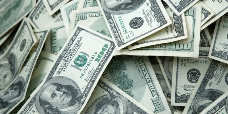 Pile of $100 dollar bills filling the screen