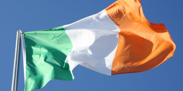 Irish flag blowing in the wind with a sky background