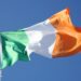 Irish flag blowing in the wind with a sky background