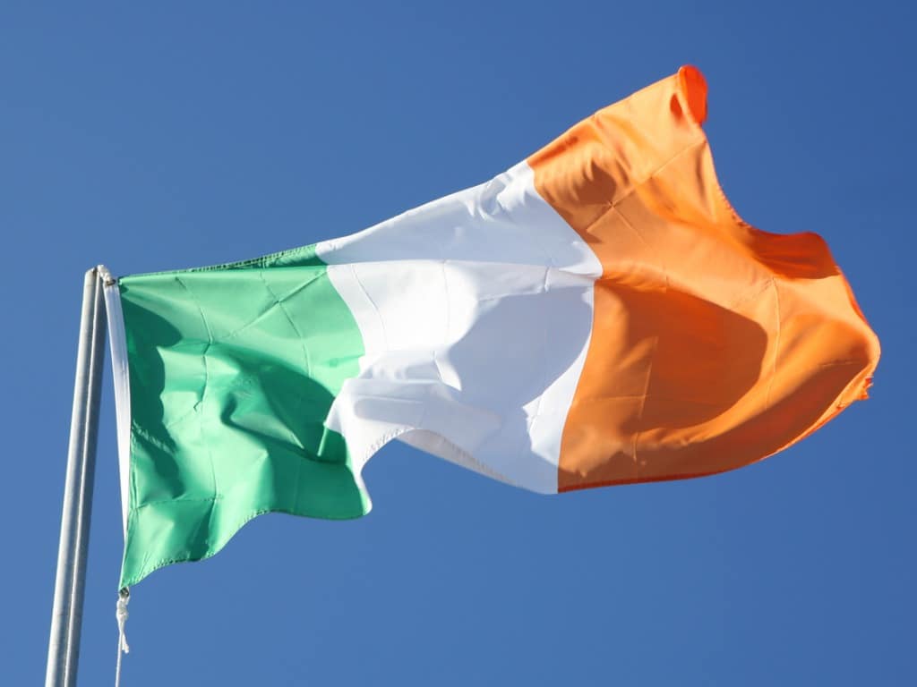 Irish flag blowing in the wind with a sky background