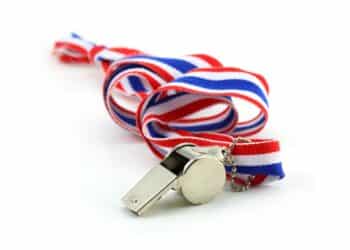Photo of a silver whistle with a red, white, and blue lanyard all against a white background