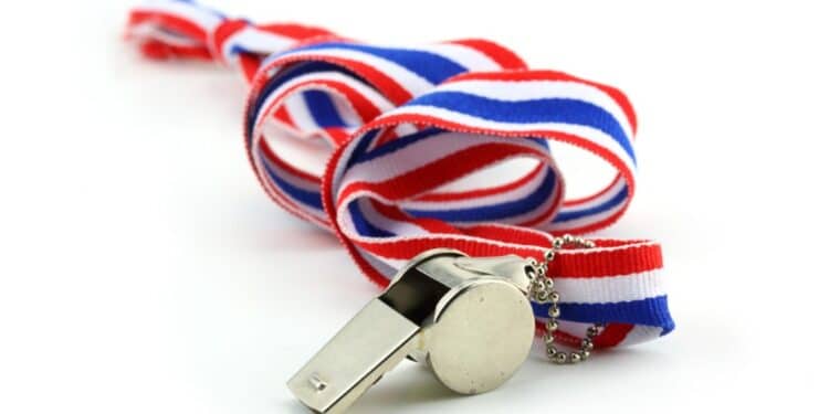 Photo of a silver whistle with a red, white, and blue lanyard all against a white background