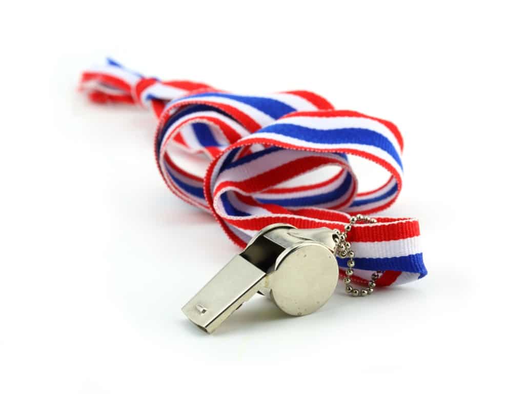 Photo of a silver whistle with a red, white, and blue lanyard all against a white background