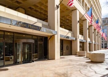 Image of the exterior of the J. Edgar Hoover building with American flags in Washington, DC