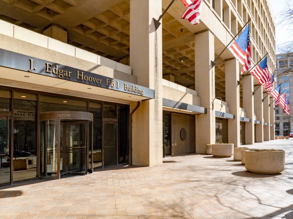 Image of the exterior of the J. Edgar Hoover building with American flags in Washington, DC