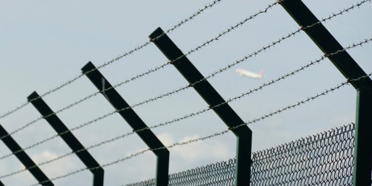 Barbed wire fence with slanted upper part pointing inwards