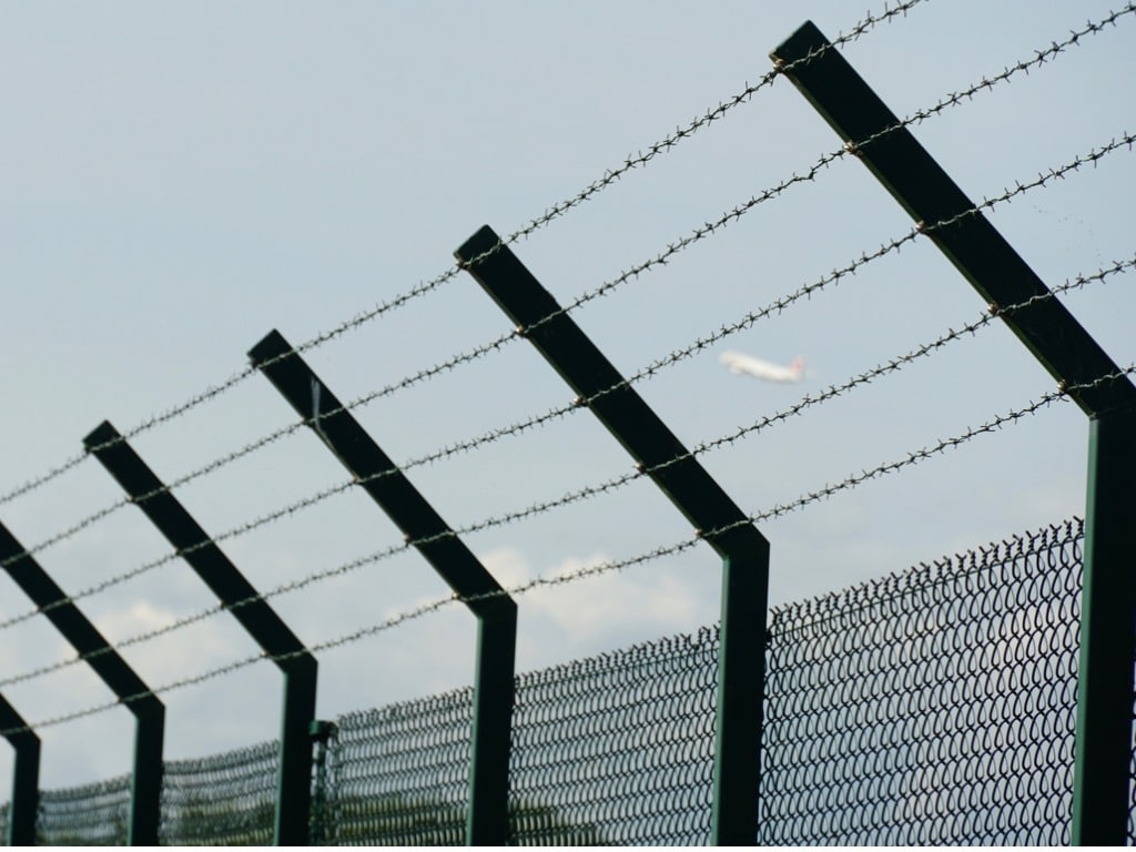 Barbed wire fence with slanted upper part pointing inwards