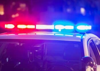 Photo of a police car with its red and blue lights switched on