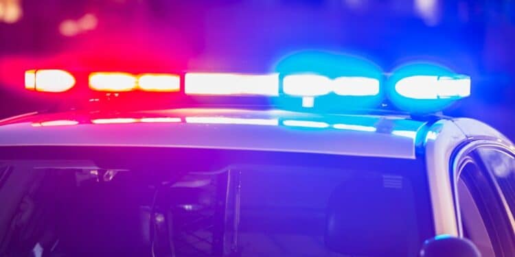 Photo of a police car with its red and blue lights switched on