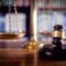 Gavel with scales in the background on a wooden desk