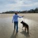 Theresa Foley walking a dog on a beach