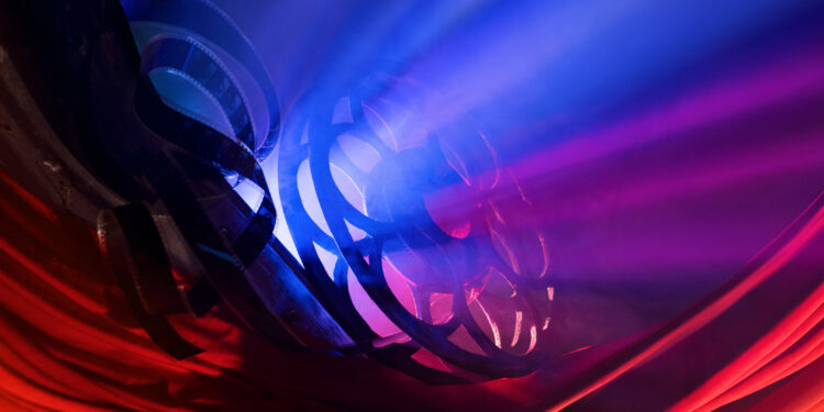 Movie reel with blue and red light seeping through.