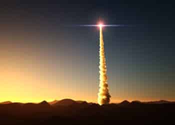 Stock photo of a rocket launching at sunrise in the desert.