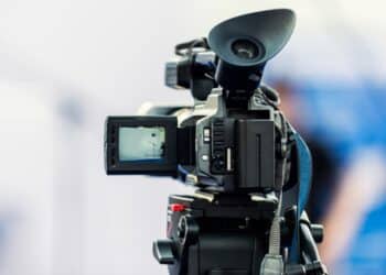 Photo of a video camera pointed at a blurry background