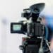 Photo of a video camera pointed at a blurry background