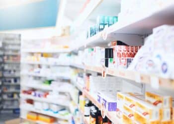 Row of medicines on shelves in a pharmacy
