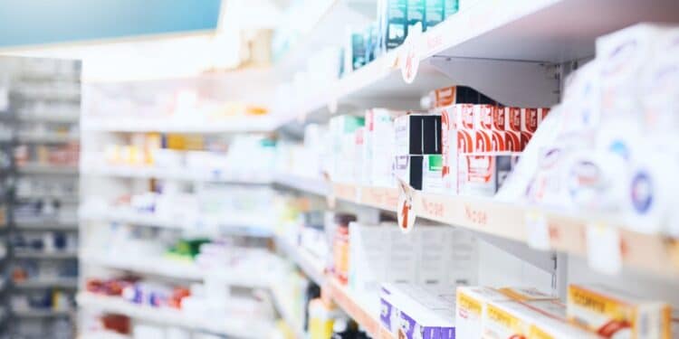 Row of medicines on shelves in a pharmacy
