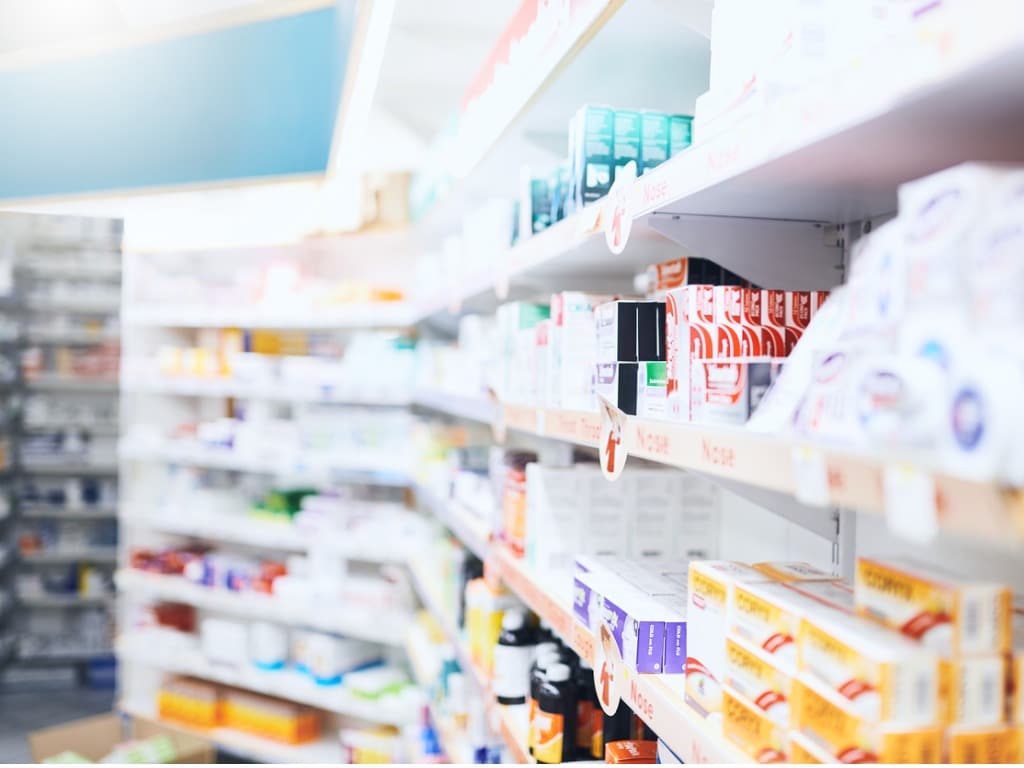Row of medicines on shelves in a pharmacy