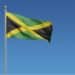 Jamaican flag waving in the wind against a blue background