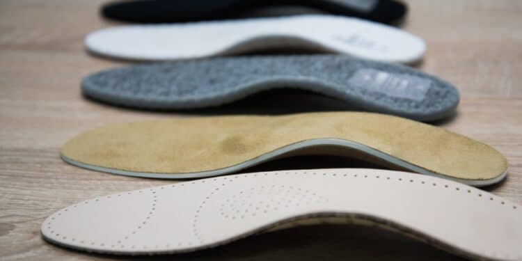 A variety of shoe inserts of different shapes and colors