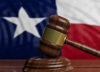 Photo of a gavel with the Texas flag in the background