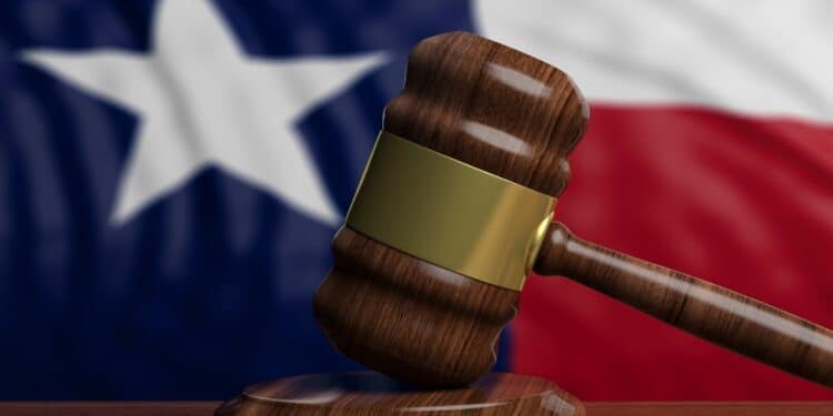 Photo of a gavel with the Texas flag in the background