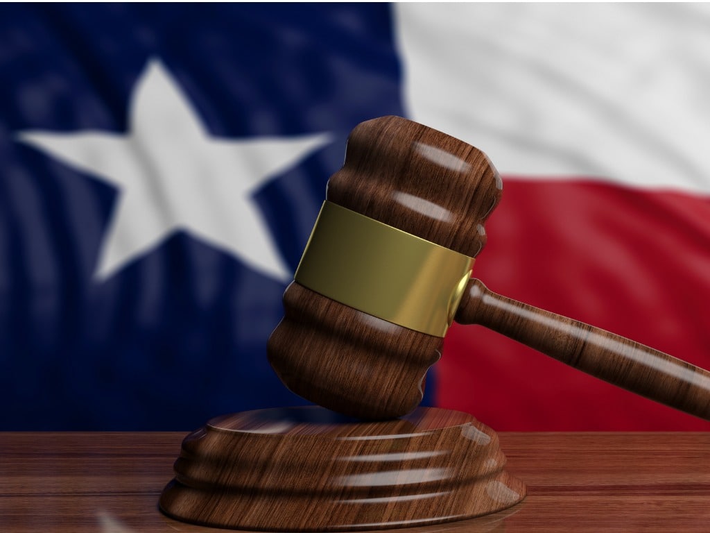 Photo of a gavel with the Texas flag in the background