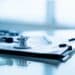Photo of a stethoscope and a clipboard on a table.