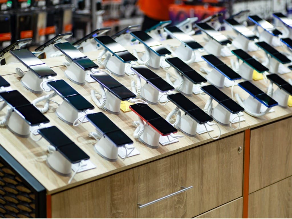 Photo of numerous smartphones on display in a store