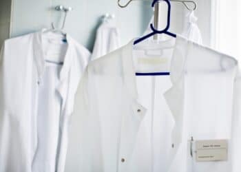 Two doctor's lab coats hanging up on clothes hangers