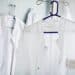 Two doctor's lab coats hanging up on clothes hangers