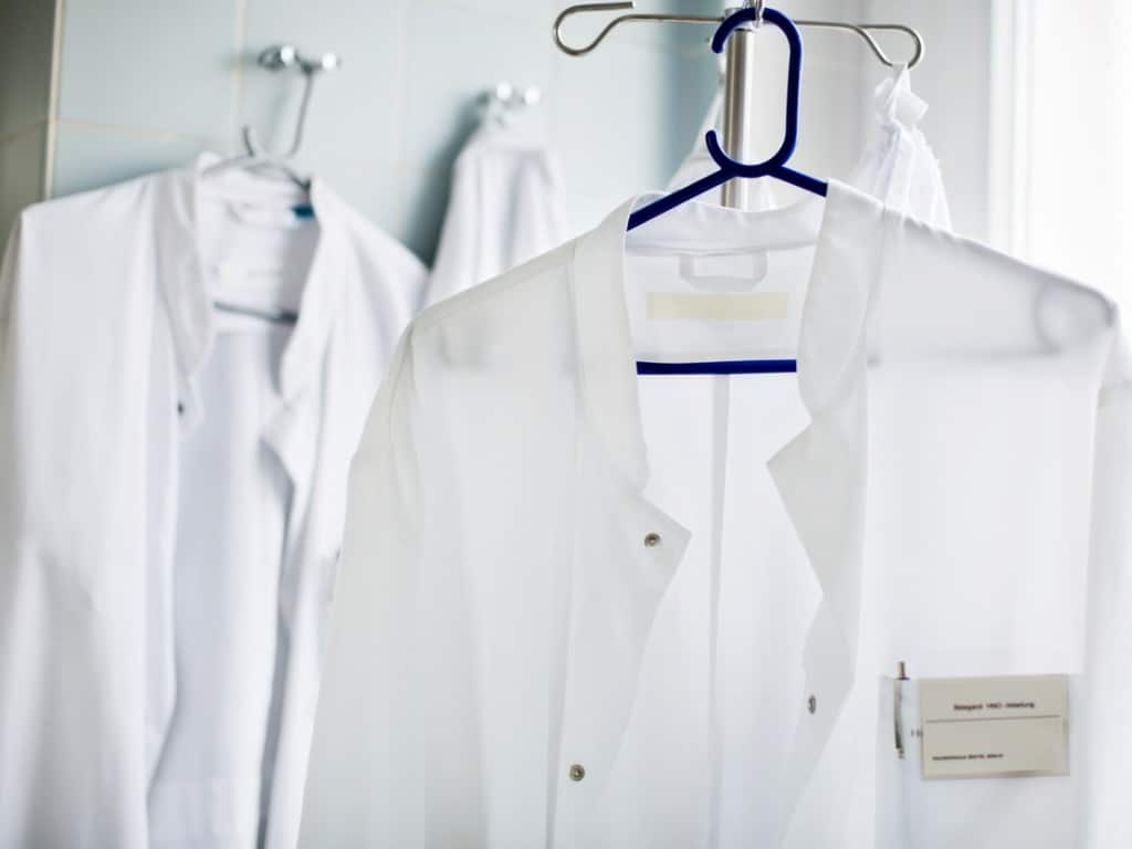 Two doctor's lab coats hanging up on clothes hangers