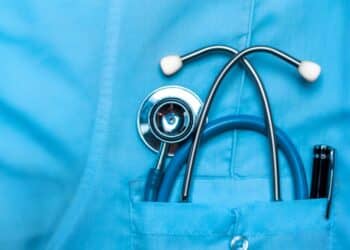 Close-up of a stethoscope in the pocket of a doctor's scrubs