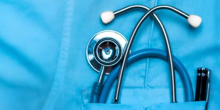 Close-up of a stethoscope in the pocket of a doctor's scrubs