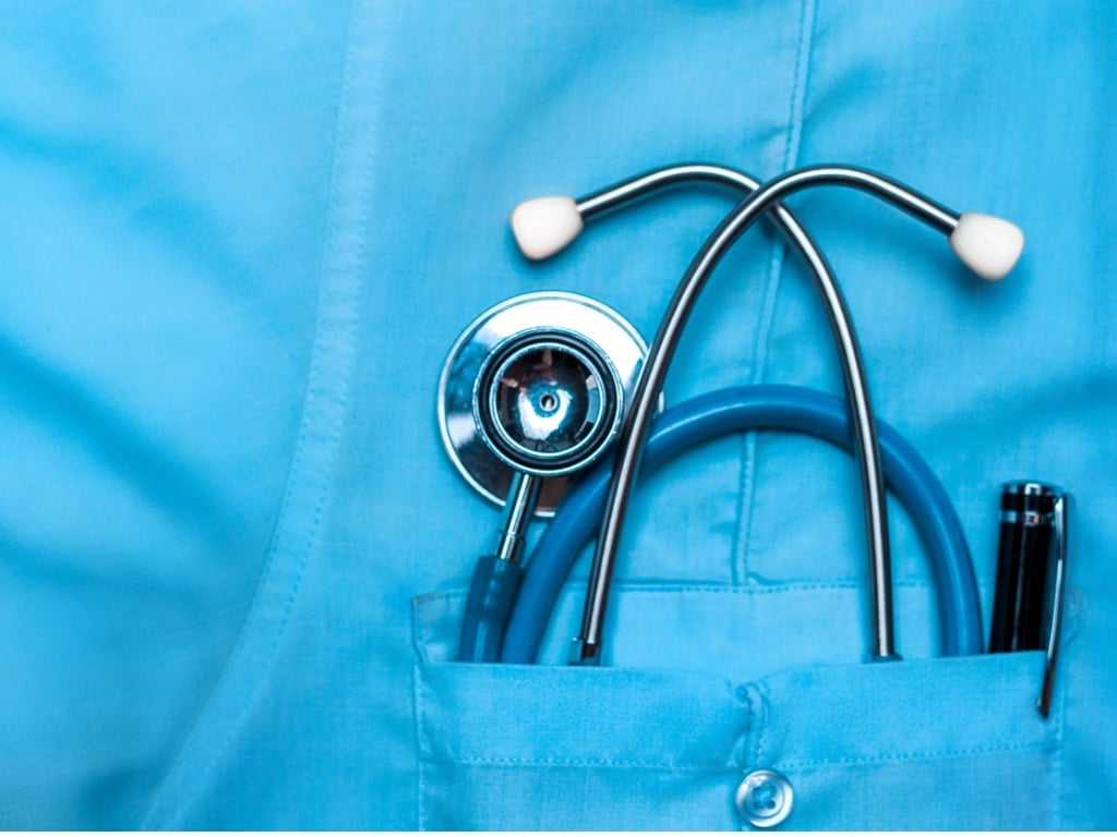 Close-up of a stethoscope in the pocket of a doctor's scrubs