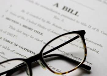 Stock image of glasses atop a bill waiting to be made law