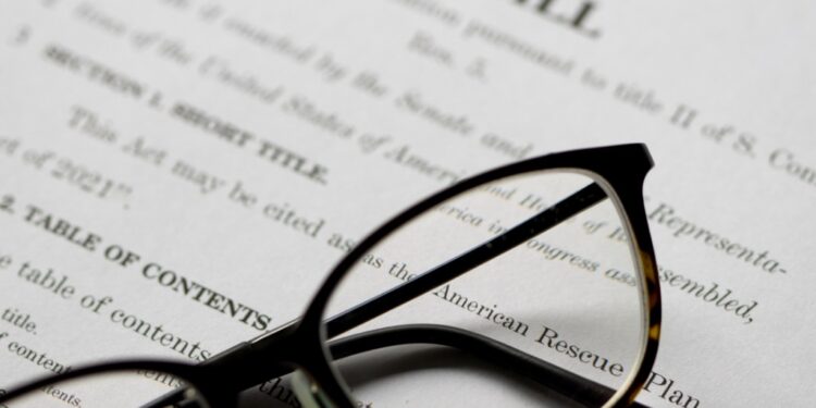 Stock image of glasses atop a bill waiting to be made law