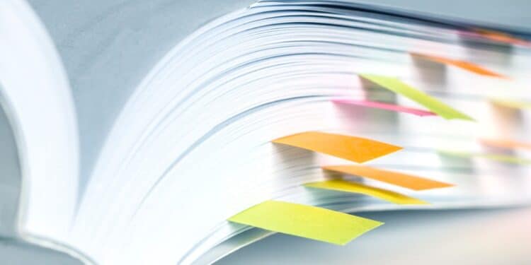 Close-up of a book with sticky tabs sticking out of the bottom