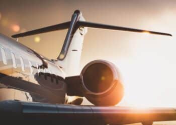 Photo of the side of a jet plane at sunset