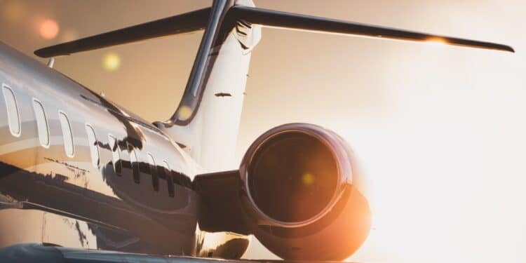 Photo of the side of a jet plane at sunset