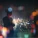 Silhouette of a young woman standing in a building overlooking city lights
