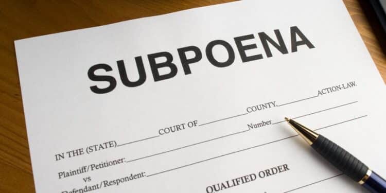 Subpoena form with a pen on a desk
