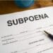 Subpoena form with a pen on a desk