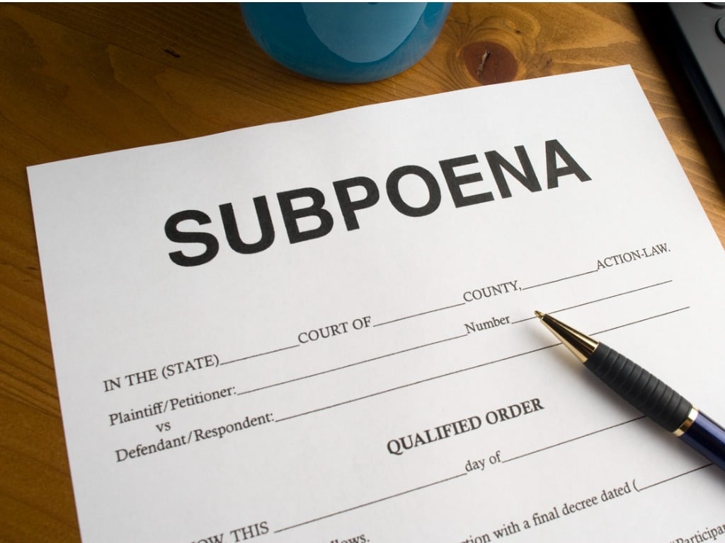 Subpoena form with a pen on a desk