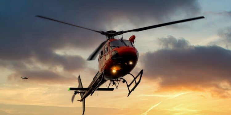 Helicopter flying in the air at sunset