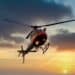 Helicopter flying in the air at sunset