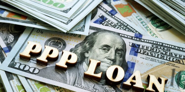 Words "PPP" loans on a pile of $100 bills