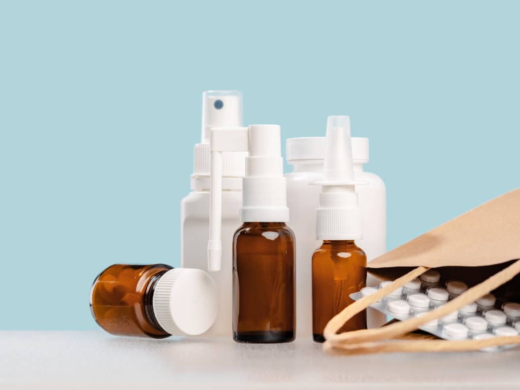 Photo of a variety of medicines: spray bottles, pills, droppers