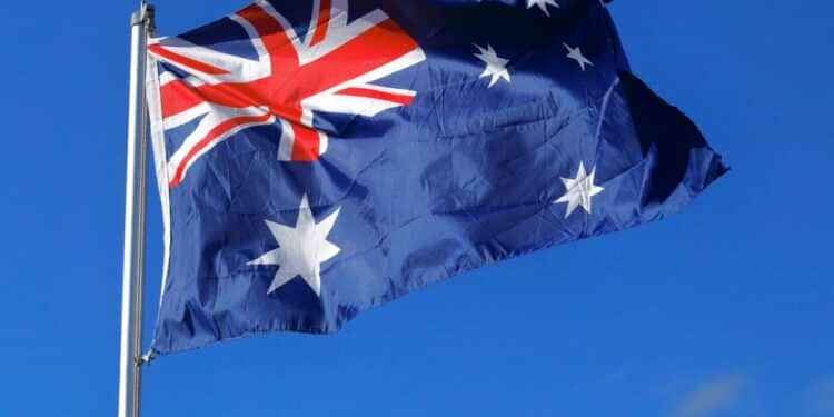 Photo of an Australian flag with blue sky behind it