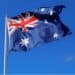 Photo of an Australian flag with blue sky behind it